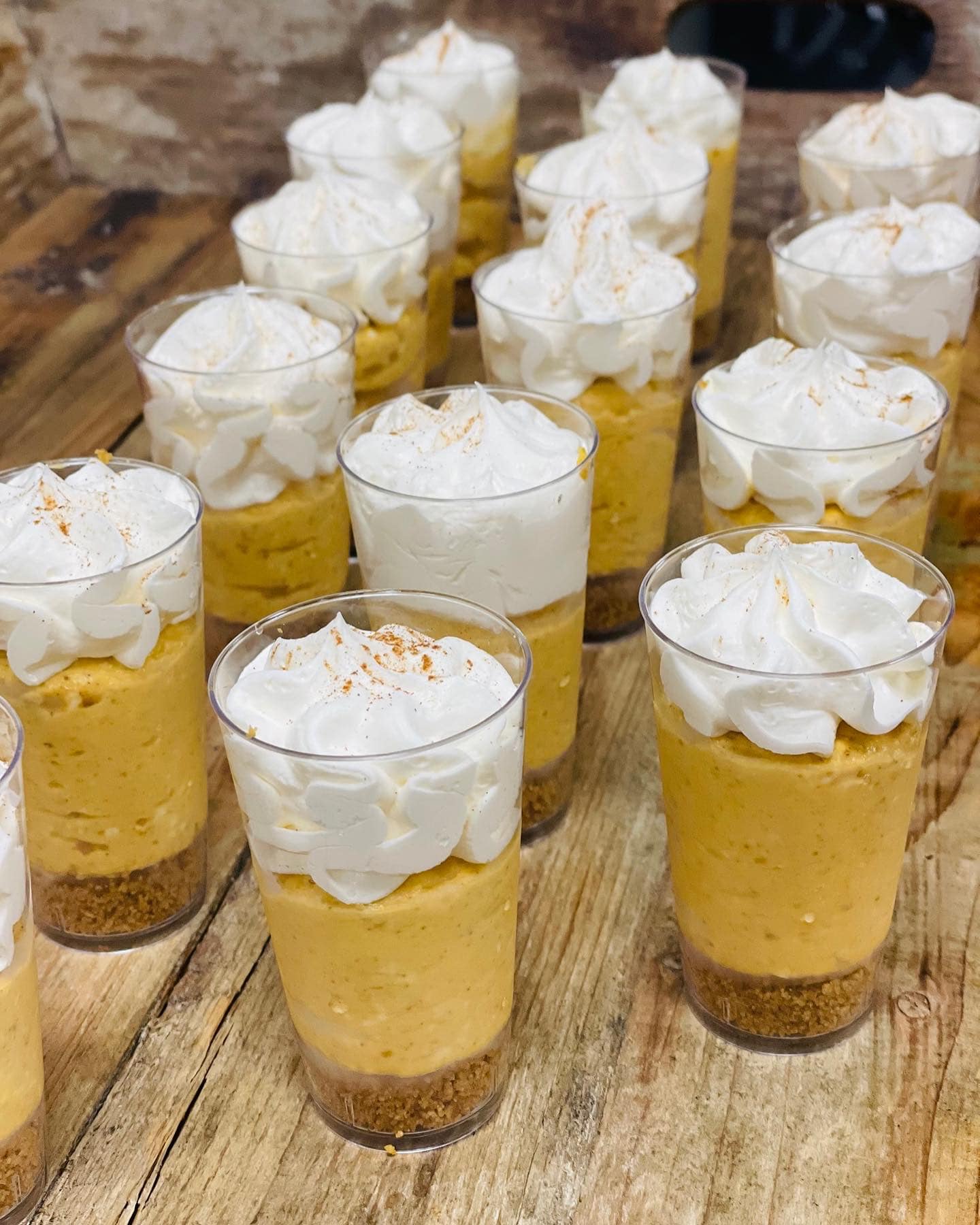 glasses filled with banana pudding with whipped cream on top for catering